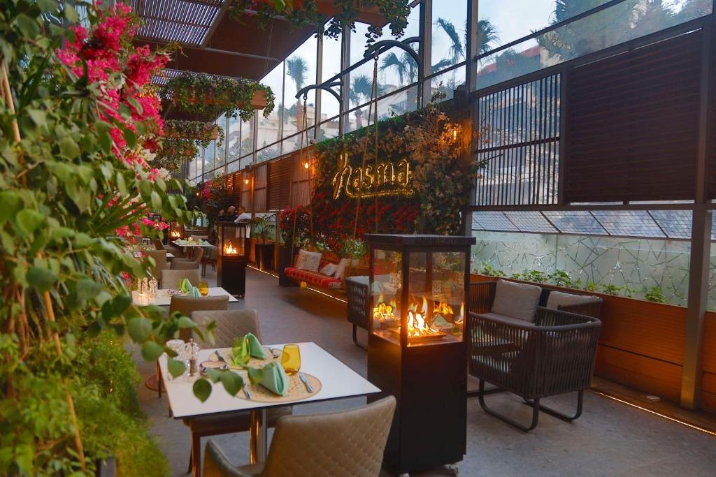 Nasma terrace with fire lamps and flowers